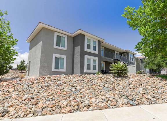 A modern two-story house with a stone foundation at West Park Apartments, Albuquerque