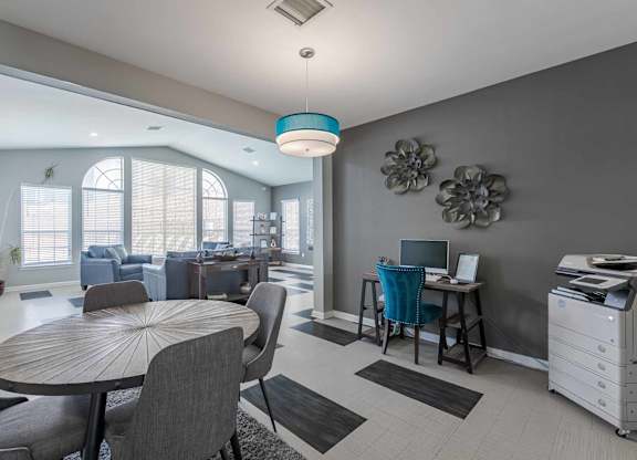 A modern dining room with a round table and chairs at West Park Apartments, Albuquerque