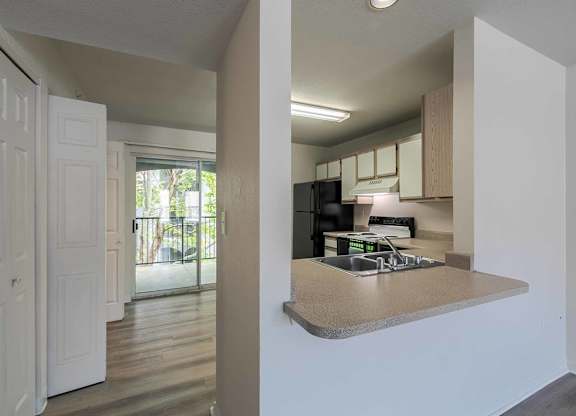 A kitchen with a refrigerator, microwave, and oven at West Park Apartments, Albuquerque