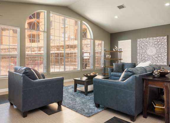 A living room with two grey couches and a coffee table at West Park Apartments, Albuquerque