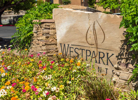 A stone sign with Westpark written on it at West Park Apartments, Albuquerque, NM