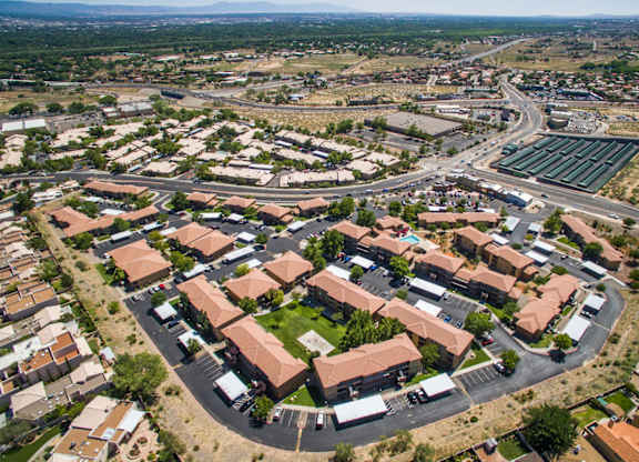 A bird's eye view of a residential area with houses and a roundabout at West Park Apartments, Albuquerque, NM, 87114