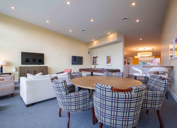 a living room with a pool table and a flat screen tv  at Woodmore Grand, Maryland, 20721