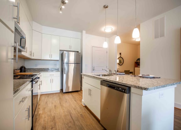 a kitchen with stainless steel appliances and granite counter tops at Woodmore Grand, Bowie, 20721