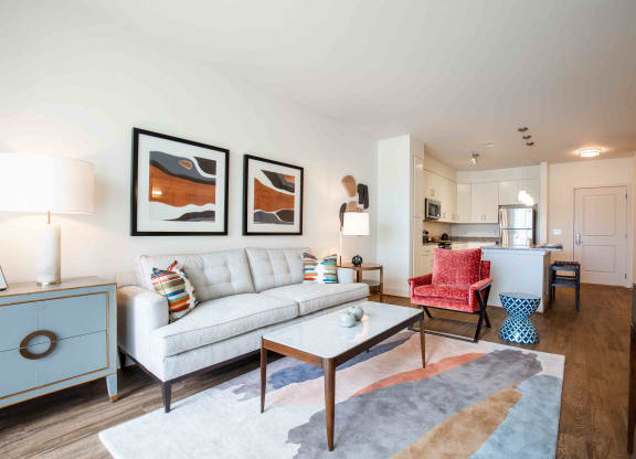 a living room with a couch and a table at Woodmore Grand, Bowie