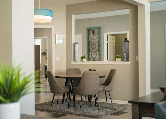 A dining room with a table and chairs at West Park Apartments, Albuquerque