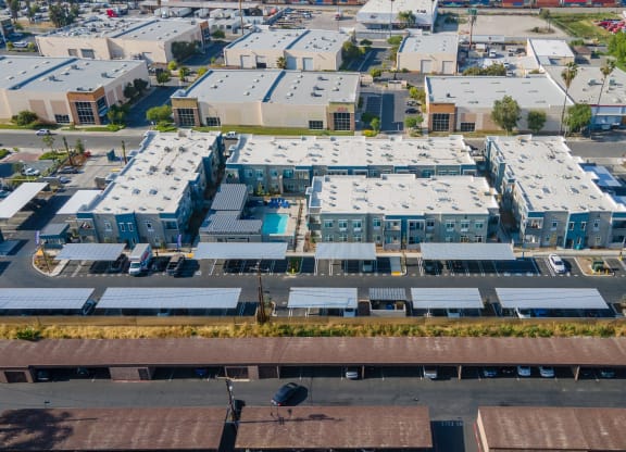 an aerial view of a group of houses with solar panels on their roofs at Loma Villas Apartments, California, 92408