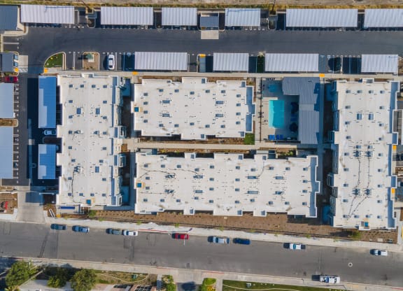 a bird's eye view of a building complex with blue and white roofs at Loma Villas Apartments, California