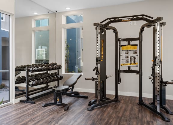a home gym with a variety of exercise equipment at Loma Villas Apartments, San Bernardino, CA