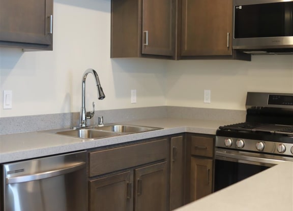 kitchen with a sink oven stove and microwave at Loma Villas Apartments, California, 92408