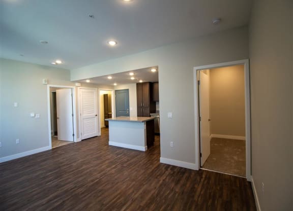 empty living room with a kitchen in the background at Loma Villas Apartments, San Bernardino, California