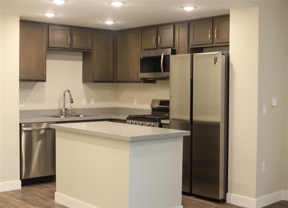 a kitchen with a large island and stainless steel appliances at Loma Villas Apartments, San Bernardino, 92408
