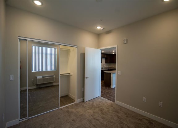a bedroom with a large mirror and a closet at Loma Villas Apartments, San Bernardino, 92408