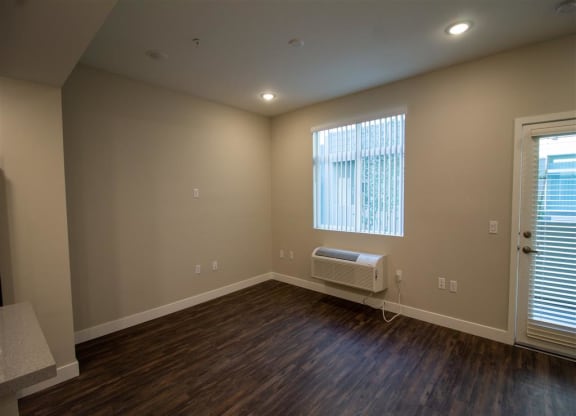 a bedroom with hardwood floors and a window at Loma Villas Apartments, San Bernardino, 92408