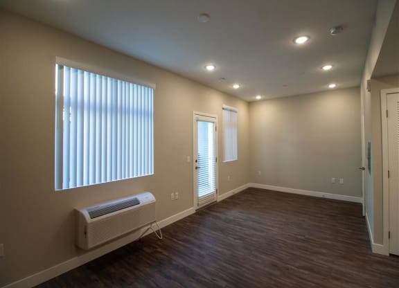 an empty room with a radiator and a large window at Loma Villas Apartments, California