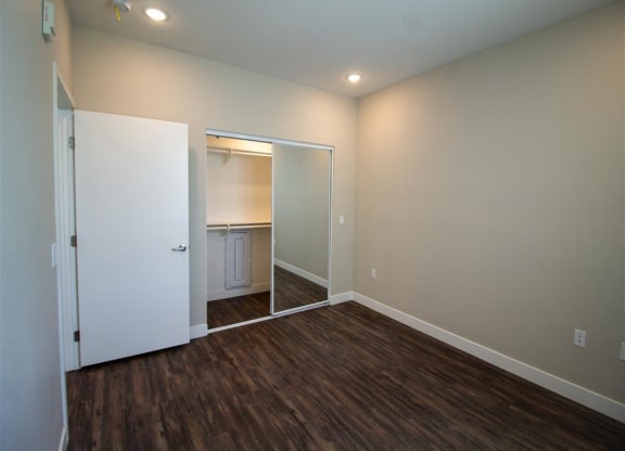 a bedroom with a closet and a door to a bathroom at Loma Villas Apartments, San Bernardino