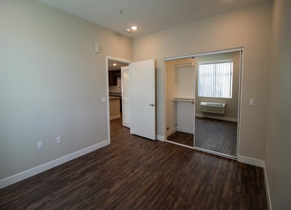 a bedroom with a large mirror and a closet at Loma Villas Apartments, San Bernardino California