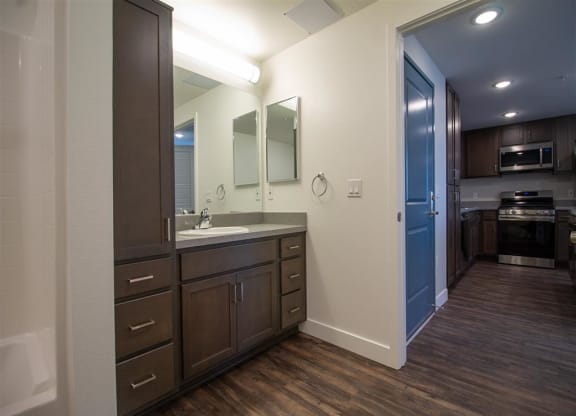 a bathroom with a sink and a mirror at Loma Villas Apartments, San Bernardino, 92408