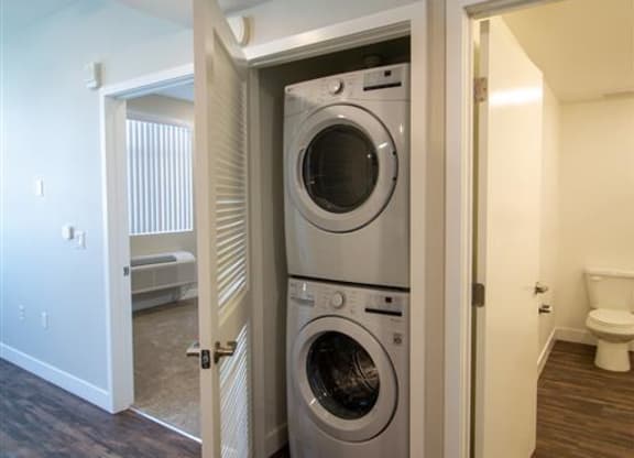 washer and dryer in a room with a toilet at Loma Villas Apartments in San Bernardino, CA