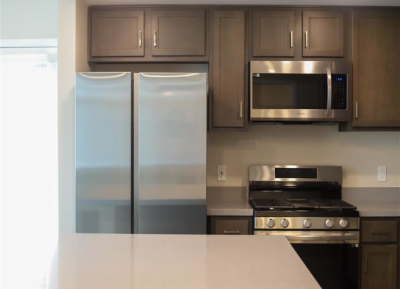 kitchen with a refrigerator stove and microwave at Loma Villas Apartments, San Bernardino, CA