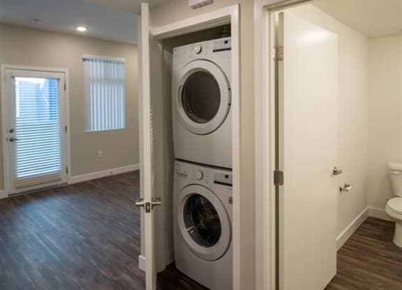 a washer and dryer in a room with a toilet at Loma Villas Apartments, San Bernardino, 92408