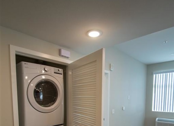 a washer and dryer in a small room at Loma Villas Apartments, San Bernardino, CA