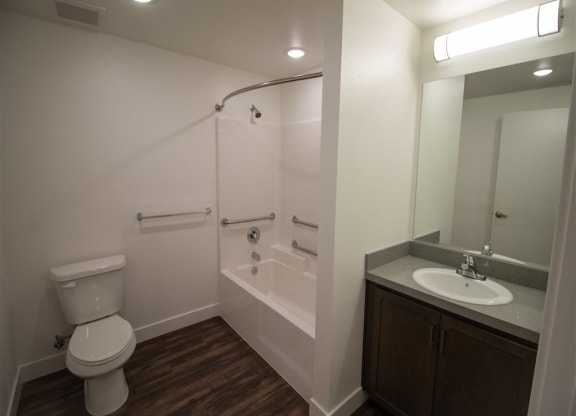 a bathroom with a toilet sink and bathtub at Loma Villas Apartments, San Bernardino, CA