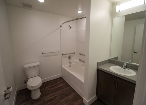 a bathroom with a toilet sink and bathtub at Loma Villas Apartments, California, 92408