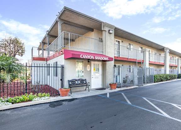 The image shows a building with the sign  at Canyon Shadows Apartments, Riverside, CA