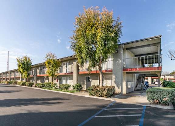 A street view of apartment buildings with a clear blue sky. at Canyon Shadows Apartments, Riverside California 