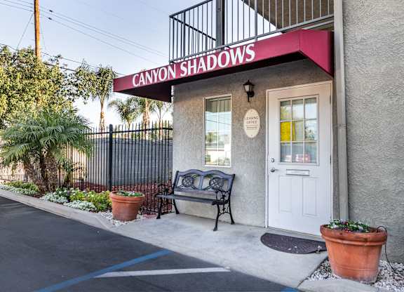 A building with a sign that says Canyon Shadows. at Canyon Shadows Apartments, Riverside California 