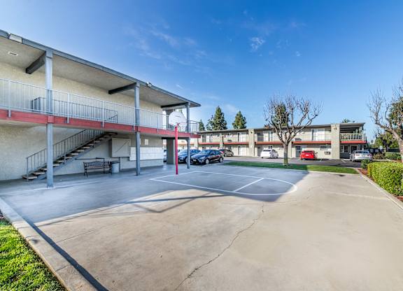 A parking lot with a building in the background. at Canyon Shadows Apartments, California, 92503