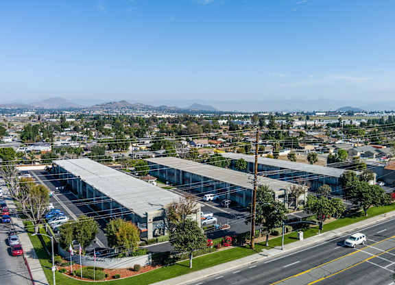 A large building with a parking lot in front of it. at Canyon Shadows Apartments, Riverside, CA  