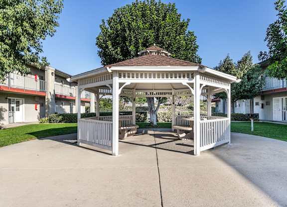 A gazebo is in the middle of a concrete courtyard. at Canyon Shadows Apartments, Riverside, CA 92503  