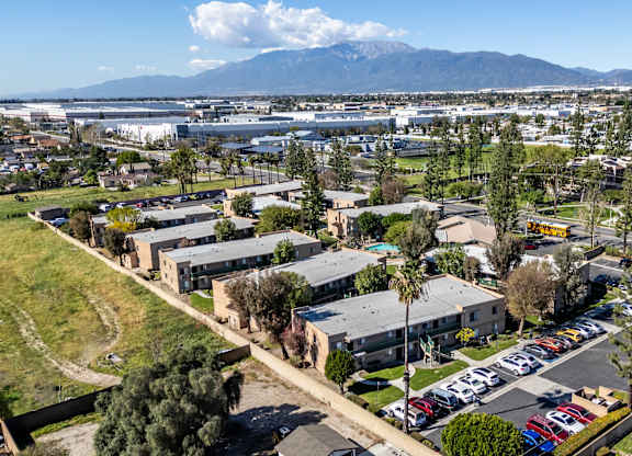 A view of a parking lot with cars and a building in the background. at Heritage Park, Rialto