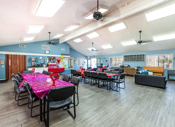 A room with tables and chairs and a ceiling fan. at Heritage Park, Rialto