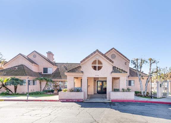 A pink house with a white fence in front. at Whispering Fountains Diamond Bar, Diamond Bar California