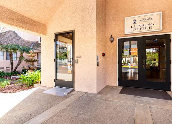 The image shows the entrance to a leasing office with two doors and a sign above them. at Whispering Fountains Diamond Bar, Diamond Bar, CA
