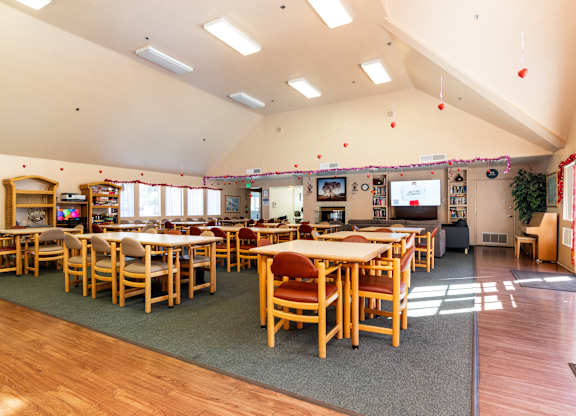 A room with tables and chairs and a green rug. at Whispering Fountains Diamond Bar, Diamond Bar, CA