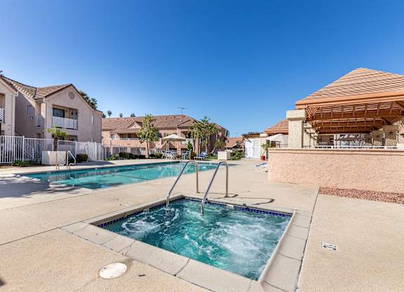 A small pool with a hot tub in the middle of a residential area. at Whispering Fountains Diamond Bar, Diamond Bar California