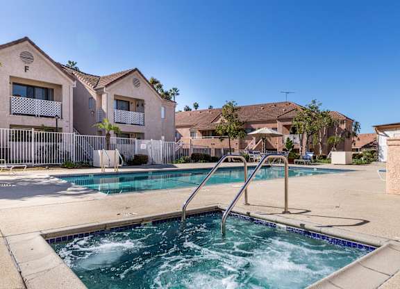 A swimming pool in front of apartment buildings. at Whispering Fountains Diamond Bar, Diamond Bar, 91765