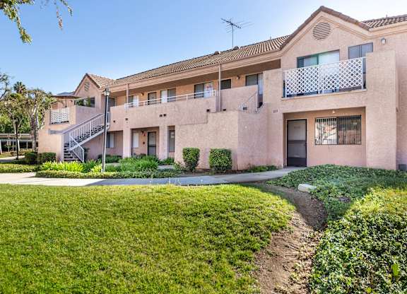 A building with a balcony and a staircase leading to the entrance. at Whispering Fountains Diamond Bar, Diamond Bar, CA 91765
