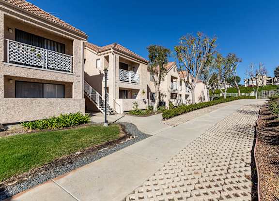 A row of houses with a sidewalk in front. at Whispering Fountains Diamond Bar, Diamond Bar, CA