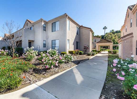 A row of houses with a sidewalk in front of them. at Whispering Fountains Diamond Bar, Diamond Bar, CA 91765