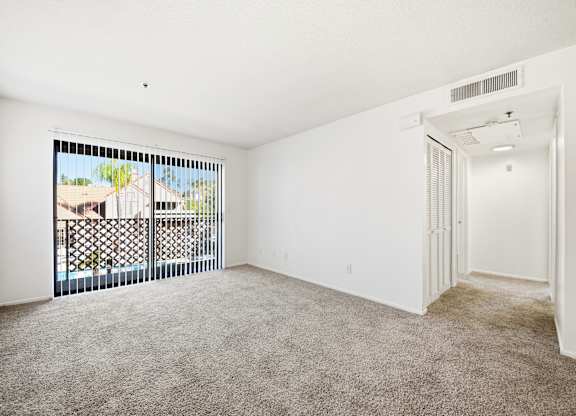 A room with a carpeted floor with balcony access at Whispering Fountains Diamond Bar, Diamond Bar, CA