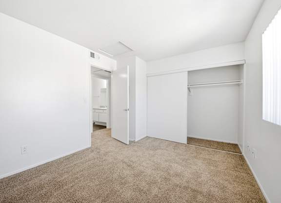 A room with a carpeted floor and white walls. at Whispering Fountains Diamond Bar, Diamond Bar California