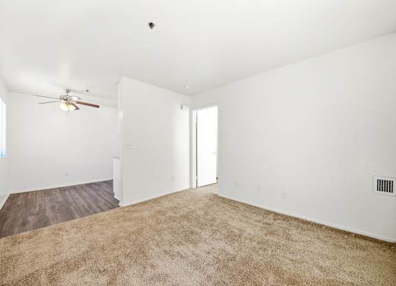 A room with a ceiling fan and carpeted floor. at Whispering Fountains Diamond Bar, Diamond Bar