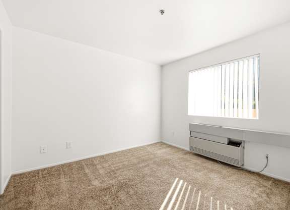 A room with a window and a carpet on the floor. at Whispering Fountains Diamond Bar, Diamond Bar, CA