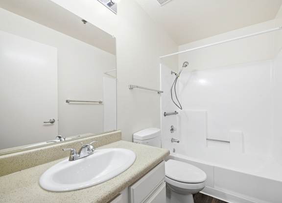 A white bathroom with a sink, toilet and bathtub. at Whispering Fountains Diamond Bar, Diamond Bar, CA 91765