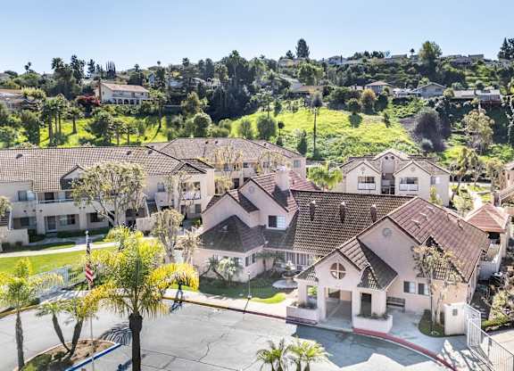 A cluster of houses with a red flag in front of one house. at Whispering Fountains Diamond Bar, Diamond Bar